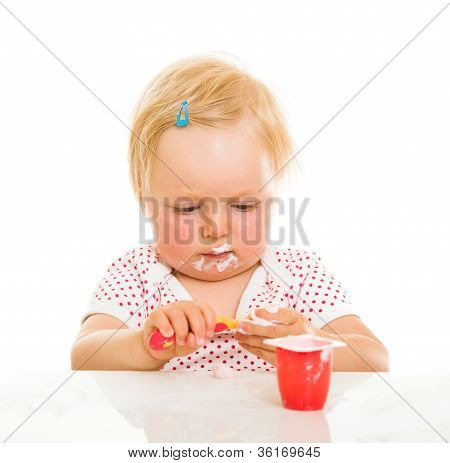 Cute Infant Girl Learining To Eat With Spoon