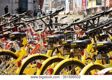 Shanghai, China - April 13, 2017: Bike Sharing In Shanghai City With Yellow Ofo Bicycles Focused Mob