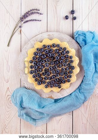 Homemade Cheesecake Decorated With Blueberry Over On White Wooden Background. Top View