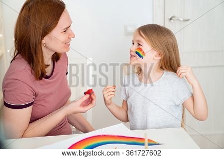Redhead Mom Draws The Blonde Child Daughter Of The Rainbow On Her Cheek. Stay Home. Flashmob Chaseth