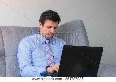 Portrait Of Freelancer Man Working Typing On Laptop At Home Sitting On Couch, Freelance Distant Work