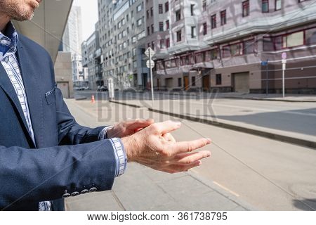 Businessman In A Blue Suit Using Small Portable Antibacterial Sanitizer Applying Antiseptic For Wash