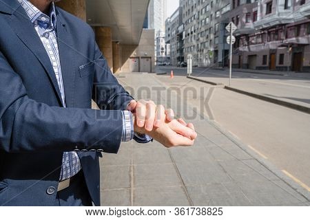 Businessman In A Blue Suit Using Small Portable Antibacterial Sanitizer Applying Antiseptic For Wash