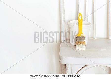 Upcycling Concept. Repainting An Retro Chair. Old White Wooden Chair Against White Wall