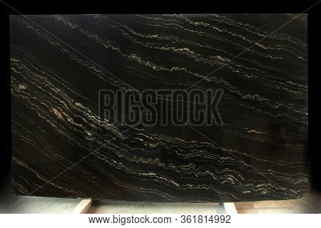 A Slab Of Natural Stone In Black Marble With Yellow Stripes Is Called Quarzite Portoro Gold