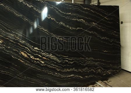 A Large Slab Of Polished Natural Stone Marble In Black With Yellow Stripes Called Quarzite Portoro G