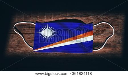 Marshall Islands National Flag At Medical, Surgical, Protection Mask On Black Wooden Background. Cor