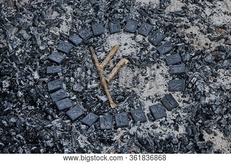 Norse Rune Fehu On Ashes Backgorund Inside The Circle Of 24 Norse Runes