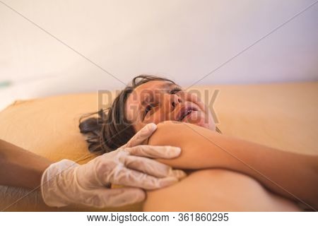 The Child Is Given An Injection, Vaccination, Doctor Makes An Injection With A Syringe To The Boy, T
