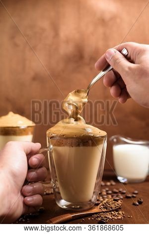 Cold Dalgon Coffee In Clear Glasses On A Dark Wooden Background. Foam From Sugar And Instant Coffee