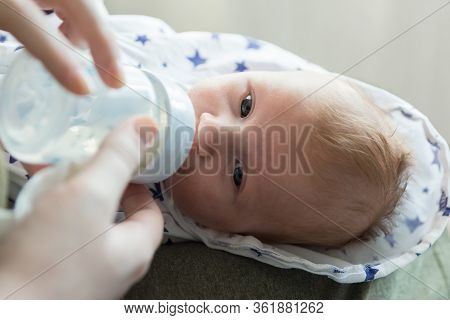 Feeding A Small Newborn Baby Formula From A Bottle. Artificial Feeding