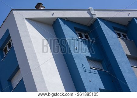 Building Facade Detail With Cold Colours, Saturated Collours And Sunlight.