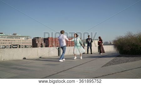 A Young Couple Dancing A Spanish Dance To Live Music. Young Couple Dancing Outdoors Under The Button
