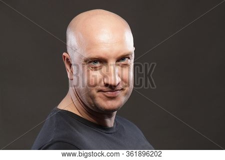 Portrait Of A Bald Man Close Up Smiling.