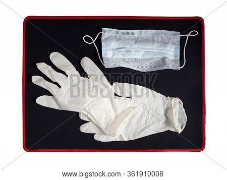 Pair Of Latex Medical Gloves And Ear-loop Mask On Black Background. Protection Concept