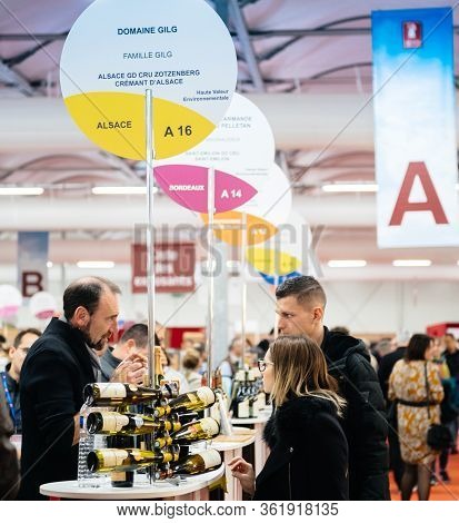 Strasbourg, France - Feb 16, 2020: Couple Buying White Wine French Gewurztraminer Wine At The Vigner