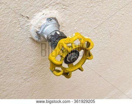 Top View Of Yellow Tap Isolated On Soft Backlight. Hydraulic Valve.