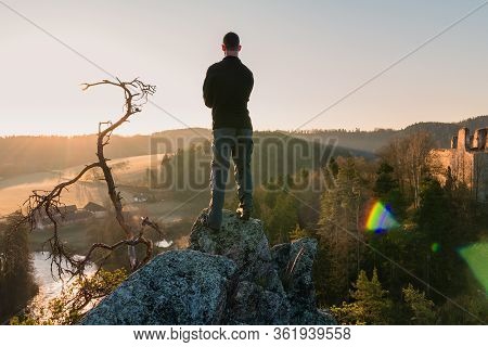 Young Man Standing On Rock And Looking To Ruin Divci Kamen From Rock. Czech Republic