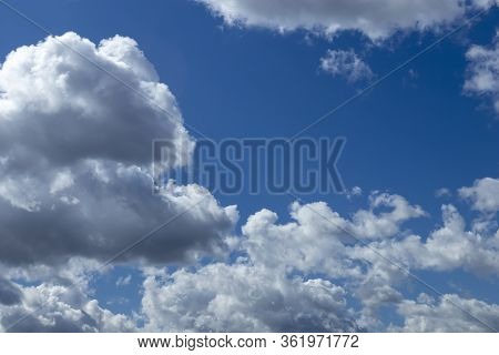 White Air Clouds Float Across The Blue Sky.