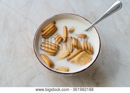 Baby Biscuits With Milk In Bowl Also For Theeting.