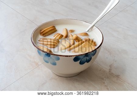 Baby Biscuits With Milk In Bowl Also For Theeting.