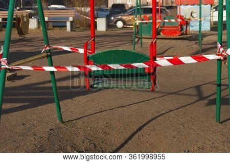 Childrens Old Wooden Green Teeterboard Fenced With Fence Signal Red Ribbon In Europian, City, Quaran