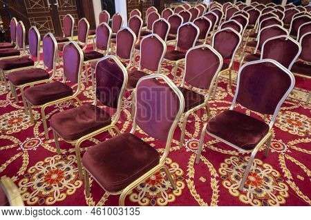 Chairs With Red Upholstery On A Red Carpet, A Hall With Seats For Lectures And Speeches