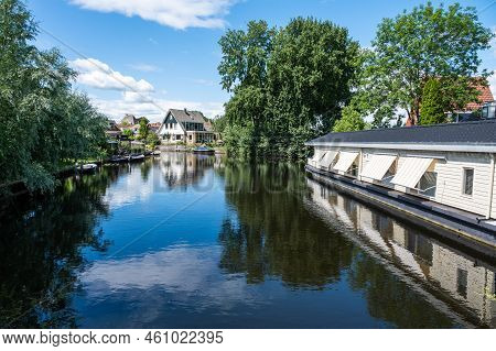 Hasselt, Overijssel, The Netherlands - 07 20 2022 - Houses And Apartments Reflecting In The Water Of