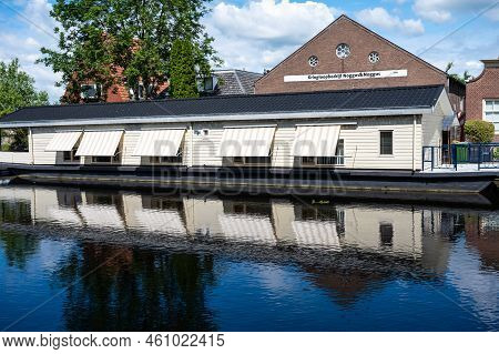 Hasselt, Overijssel, The Netherlands - 07 20 2022 - Wooden Houses At The Banks Of Te River, Reflecti