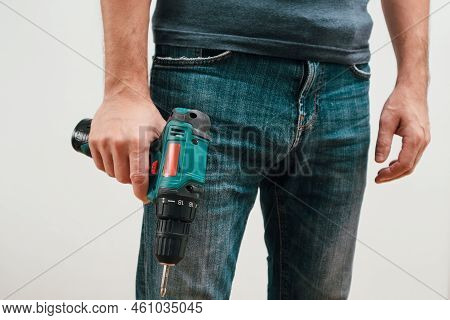 Hand Holding Cordless Drill. Handyman With A Tool Screwdriwer Drill. Electrician With Drill. Worker 