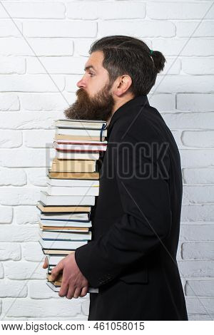Portrait Of A Funny Teacher Or Professor With Book Stack. Thinking Serious Mature Teacher. Books Sta