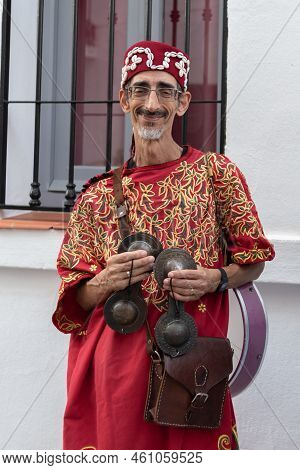 Frigiliana, Malaga, Spain, August 27, 2022: Arab Musician With Cymbals And Red Djellaba At The Frigi