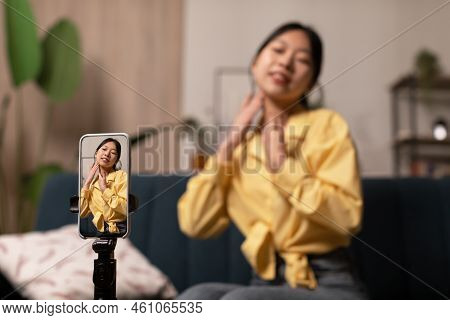 Japanese Lady Blogger Making Video Doing Facial Massage At Home