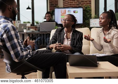 Business People Brainstorming Ideas At Work, Planning Project Presentation With Documets And Laptop.