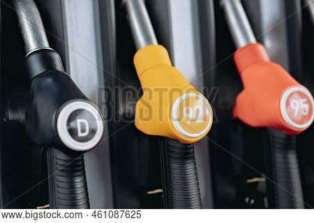 Petrol Pump Filling Fuel Nozzles At Gas Station