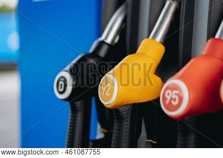 Petrol Pump Filling Fuel Nozzles At Gas Station. Image With Selective Focus
