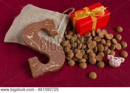 Dutch Sinterklaas Tradition: A Chocolate Letter, A Present And A Bag With Candy Called Pepernoten.