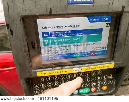 Strasbourg, France - Mar 31, 2022: Pov Male Hand Using Parkeon Parking Meters With Digital Display S