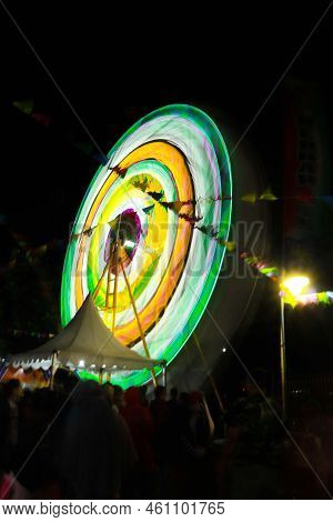 Ferris Wheel At Night Festival In Slow Motion Photo. High Roller