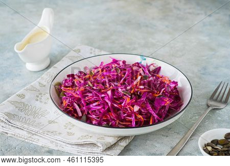 Coleslaw Salad Of Red Cabbage And Carrots With Mayonnaise Dressing In A White Bowl On A Gray Concret