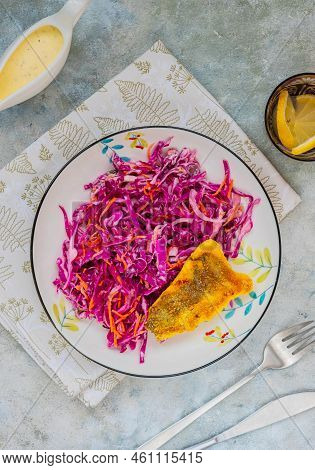Grilled Fish With Red Cabbage And Carrot Colslow Salad With Mayonnaise Dressing In A White Bowl On A