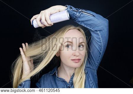 Dry Shampoo. Blonde Girl Sprays Shampoo On Her Hair. The Problem Of Oily Hair While Traveling. An Em