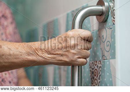 Asian Senior Or Elderly Old Lady Woman Patient Use Toilet Bathroom Handle Security In Nursing Hospit