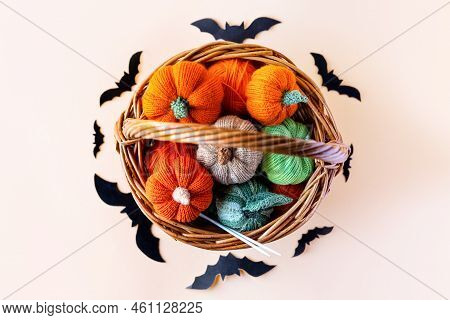 Knitted Orange Green And Beige Pumpkins In A Basket And Black Batson On A Orange Background, Knittin