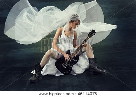Sposa suonando la chitarra Rock su sfondo scuro artistico