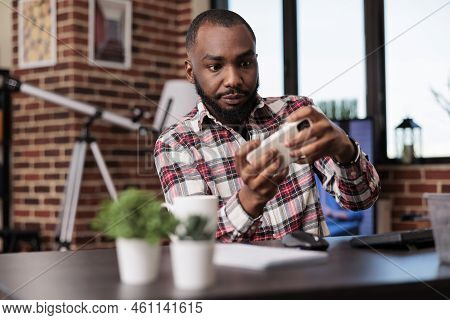 African American Man Playing Video Games On Mobile Phone, Having Fun With Online Gaming Competition 