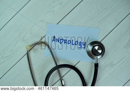 Concept Of Andrology Write On Sticky Notes With Stethoscope Isolated On Wooden Table.