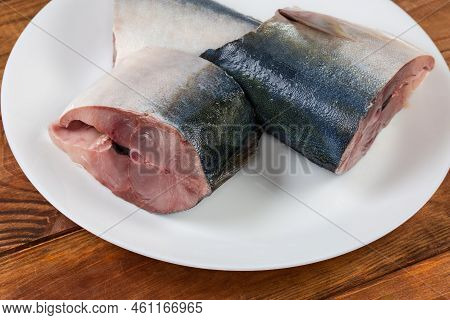 Raw Pieces Of The Chilled Japanese Amberjack Or Yellowtail On A White Dish, Close-up In Selective Fo