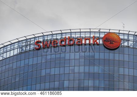 Swedbank Central Office Building In Latvia. Swedbank Inscription On The Wall Of The Glass House. Rig