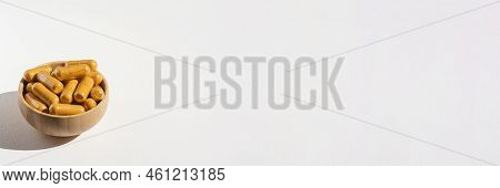 Turmeric Plus Black Pepper Extract Gelatin Capsule Close Up In Soft Focus. Herbal Supplement Organic